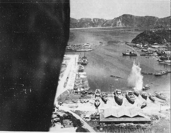 Suo (now Suao) harbor under attack by a PB4Y-1 aircraft of US Navy squadron VPB-104, eastern Taiwan, 22 Apr 1945, photo 4 of 4