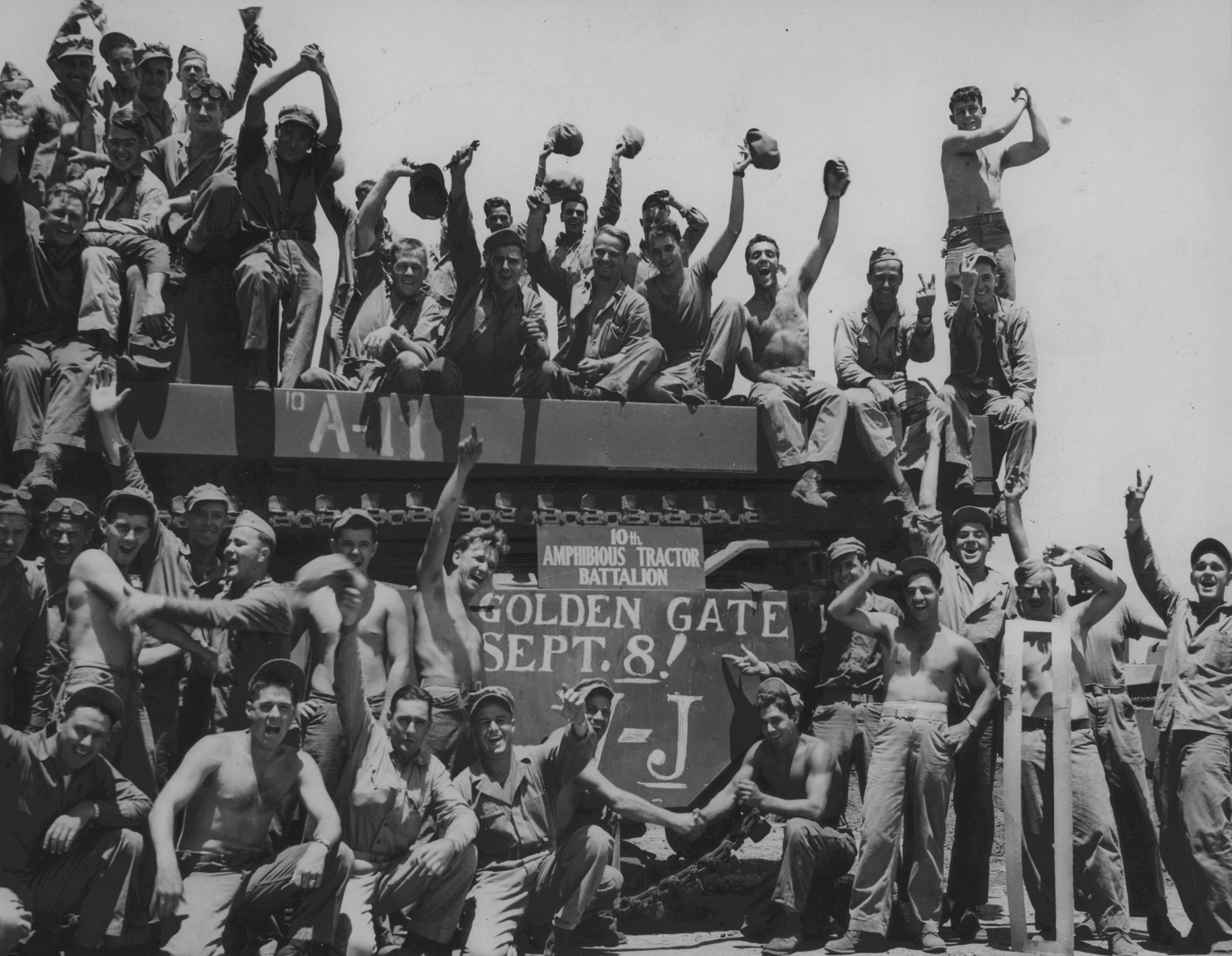Men of US Marines 10th Amphibious Tractor Battalion celebrating victory over Japan, Aug 1945