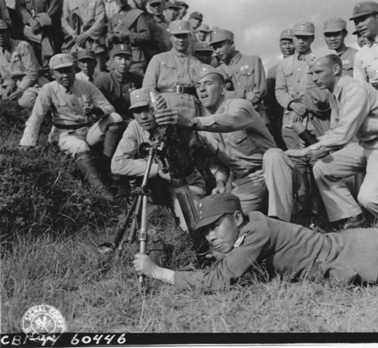 US soldiers instructing Chinese soldiers on the use of a 60-mm mortar at the Kunming Infantry School, Yunnan Province, China, 23 Sep 1944