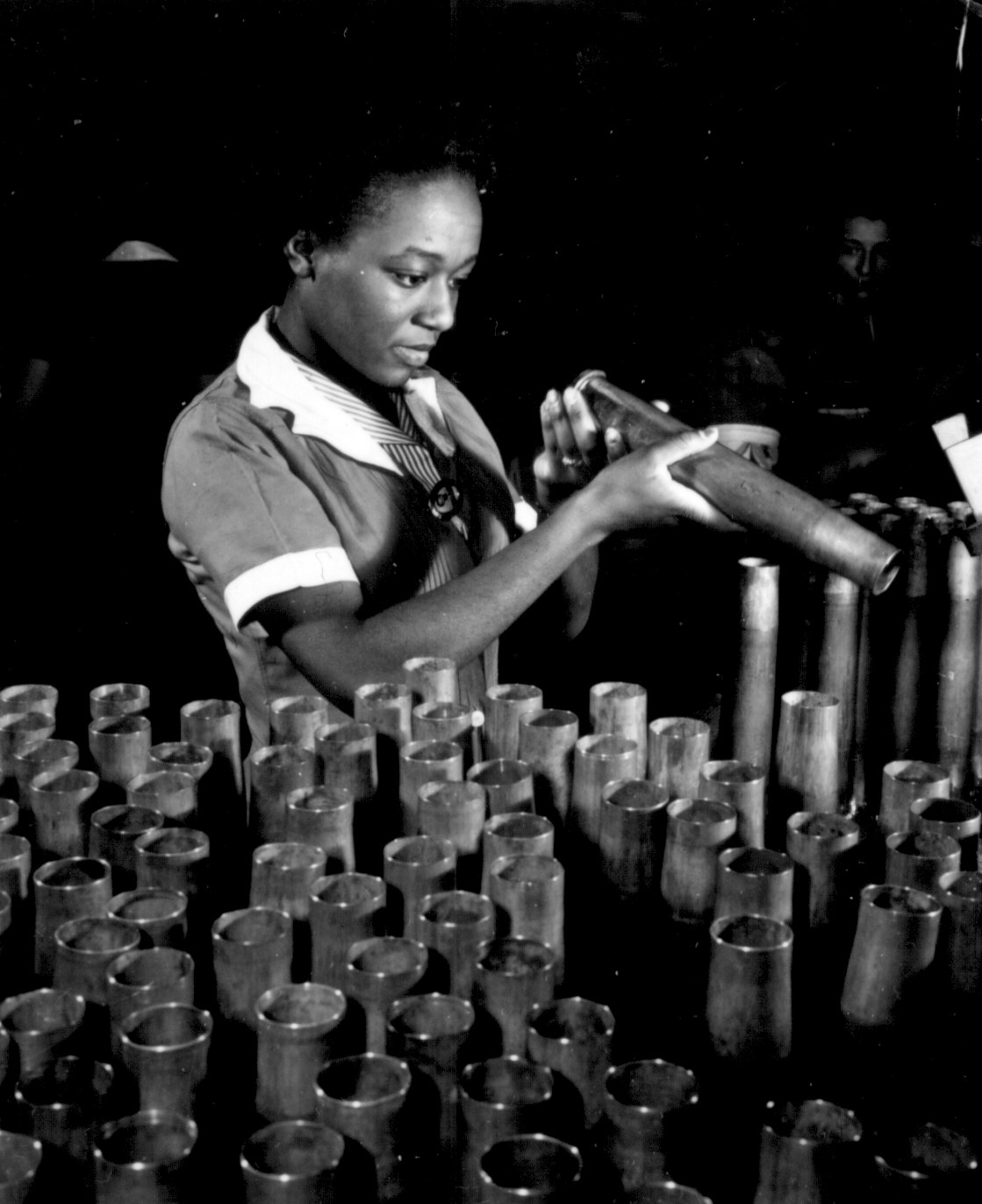 African-American factory worker Bertha Stallworth inspecting a 40-mm artillery shell, Frankford Arsenal, Philadelphia, Pennsylvania, United States, date unknown