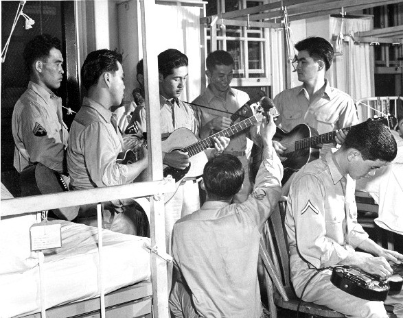 Japanese-American members of US Army entertaining wounded soldiers at Walter Reed Hospital, Washington, DC, United States, date unknown, photo 1 of 2