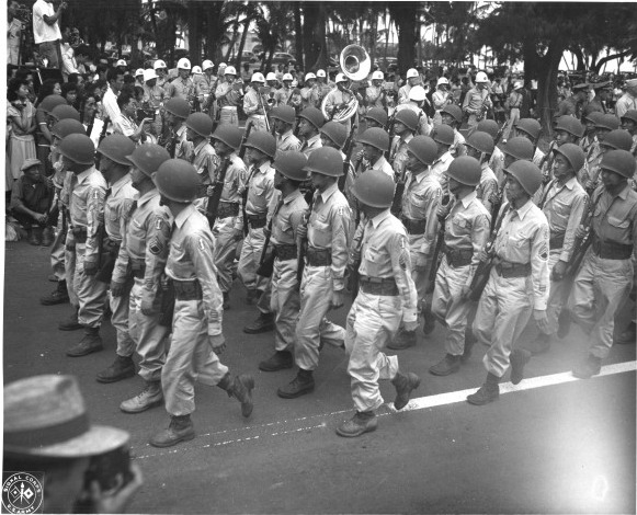 Japanese-American troops of US 442nd Regimental Combat Team marching in the Veterans Day Parade at Kapiolani Park, Honolulu, US Territory of Hawaii, 15 Aug 1946, photo 2 of 2