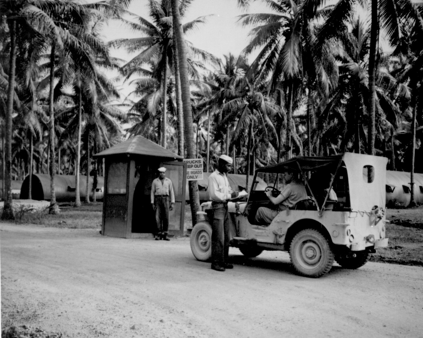 African-American guards Seamen 1st Class Dook Bland and Taft Gray guarding the entrance to the US Navy base at Espiritu Santo, New Hebrides, date unknown
