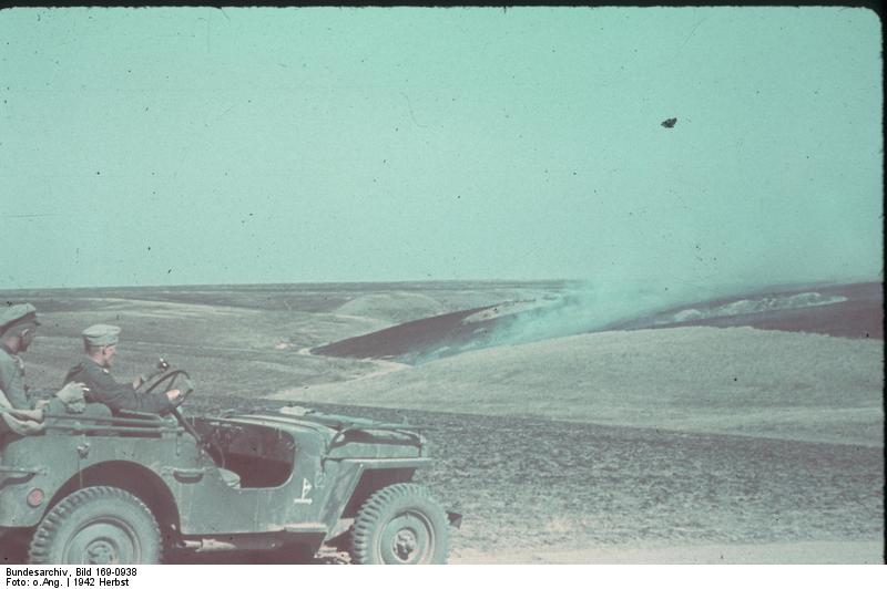 German troops in a vehicle observing a prairie fire near Stalingrad, Russia, 23 Sep 1942