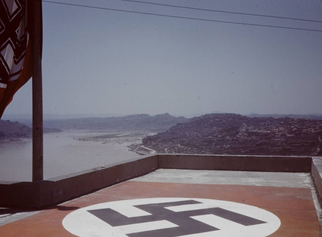 Large German flag painted on the roof of the German embassy in Chongqing, China to alert against Japanese bombers, circa 1939