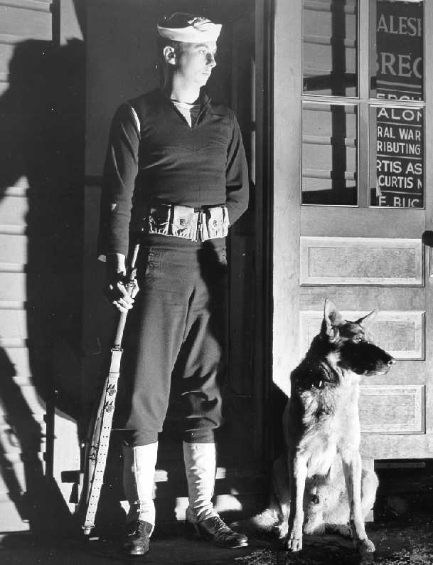US Coast Guard sentry and dog at their post during WW2