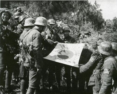 Chinese soldiers with a captured Japanese flag, China, circa 1940s