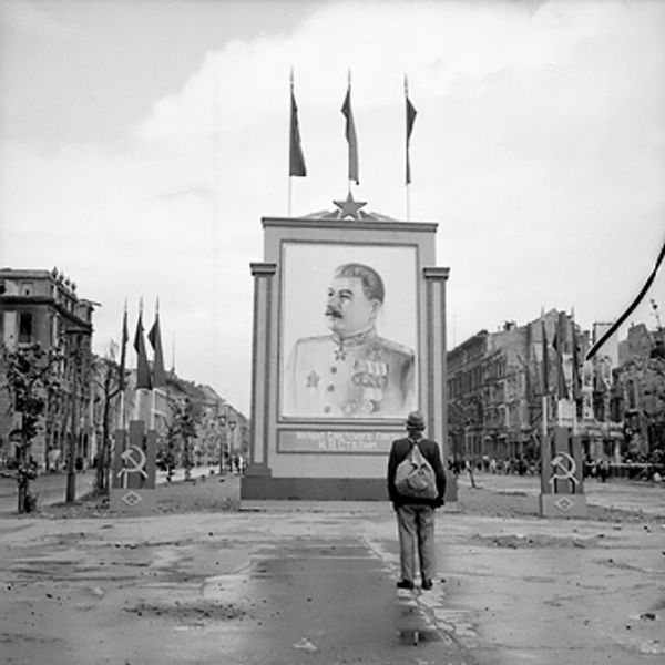 A German civilian looks at a vast painting of Stalin on the Unter-den-Linden, Berlin, Germany, 3 Jun 1945