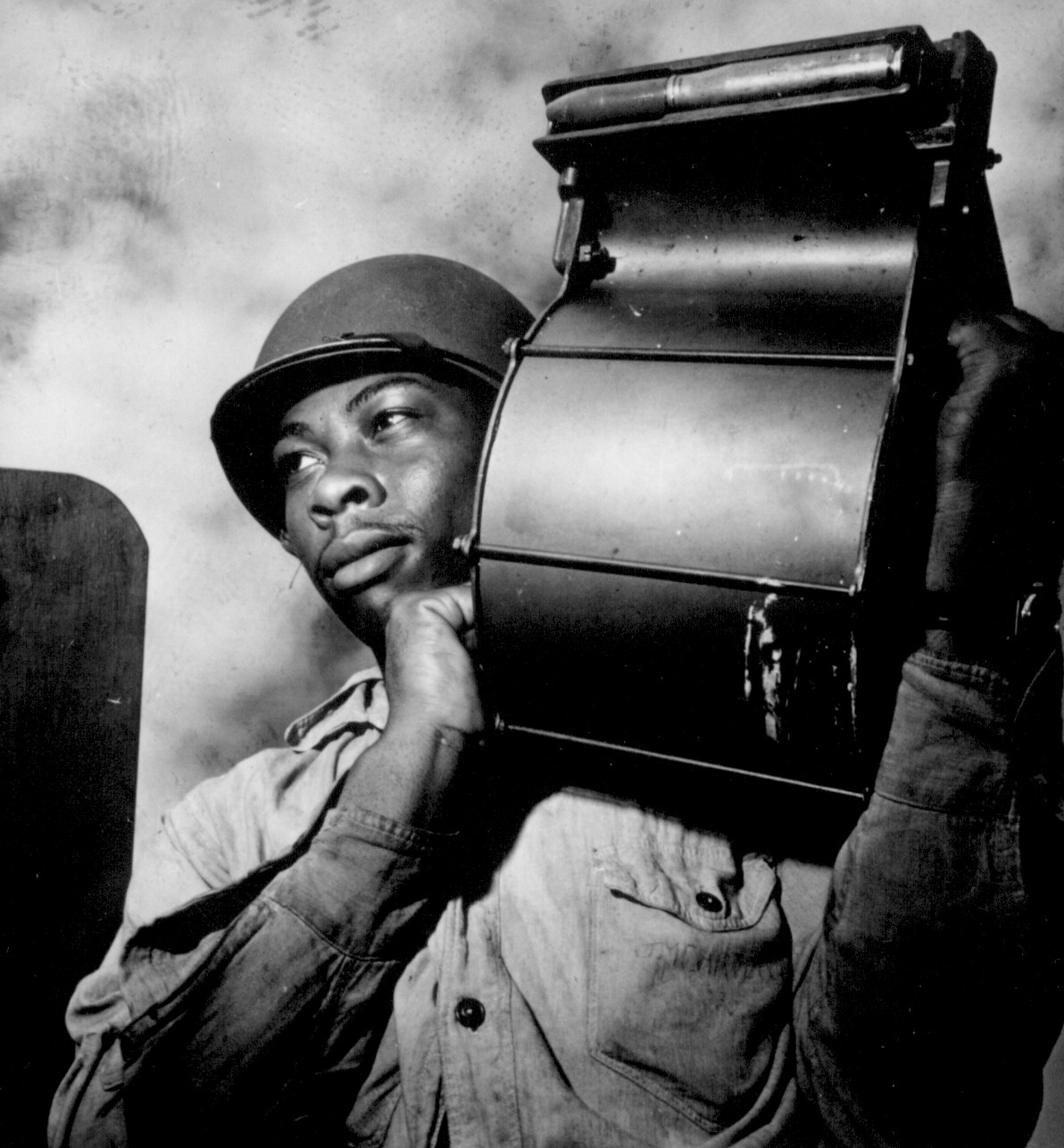 US Navy African-American Miles Davis King carrying a loaded magazine for a 20-mm gun aboard CVE USS Tulagi en route to France, Aug 1944