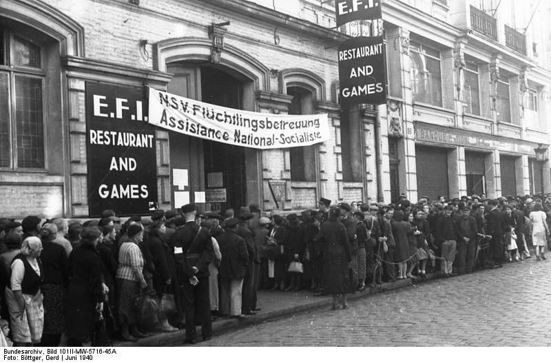 Refugees lining up outside a support center for refugees set up by the German occupation, Cherbourg, France, Jun 1940