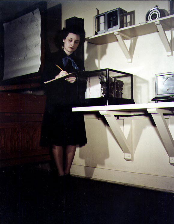 WAVES Aergrapher's Mate 2nd Class Ethel E. Helter took readings from a weather recording instrument, Naval Air Station, Moffett Field, California, United States, circa 1944-1945
