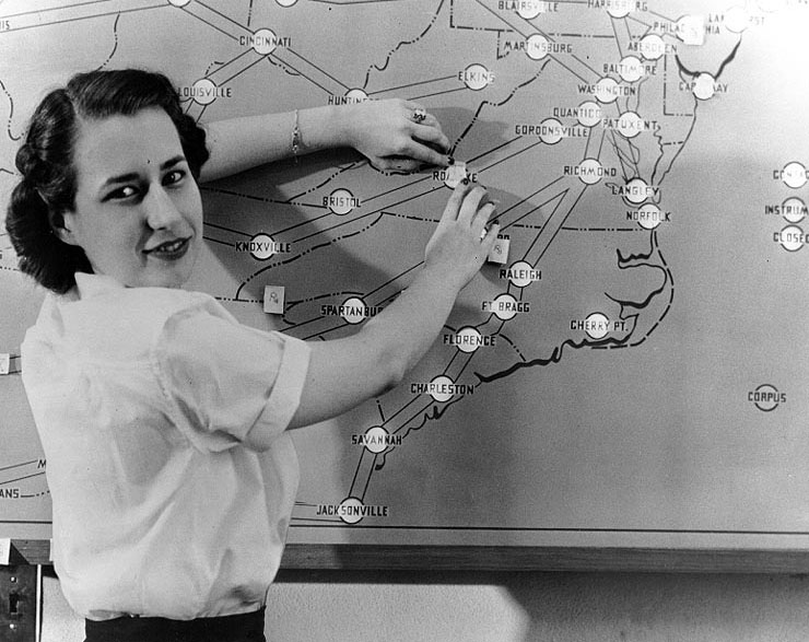Enlisted WAVES member checking a label on a Naval air station weather board, United States, 13 Jul 1943