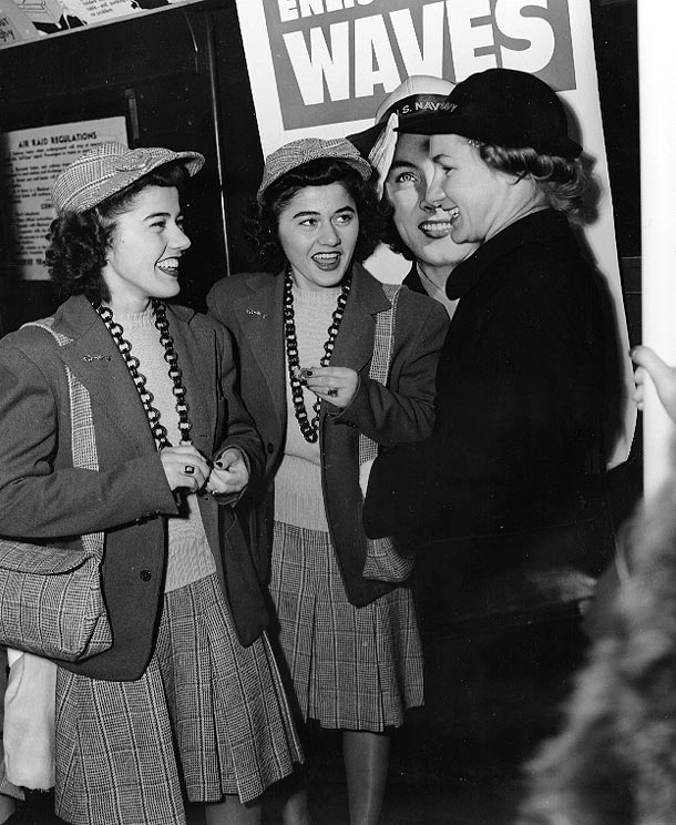 Twin sisters Ann Louise Budnick and Jule Louise Budnick talking with a WAVE personnel, New York City, New York, United States, 8 Feb 1943