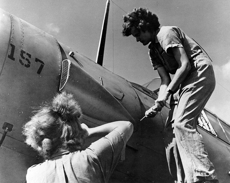WAVES Aviation Machinist's Mates Bernice Sanbury and Mary Arnold removing an access panel behind the engine of a SNJ training plane, Naval Air Station, Jacksonville, Florida, United States, Nov 1943