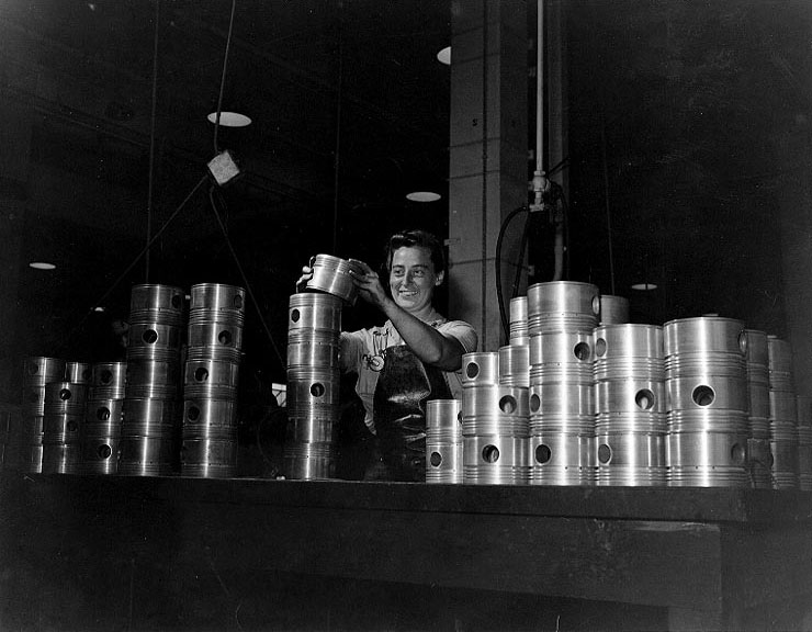 WAVES Aviation Machinist's Mate 2nd Class Lavina B. Bierer stacking aircraft engine pistons in the Engine Overhaul Shop at Naval Air Station Kaneohe, US Territory of Hawaii, 9 Jul 1945