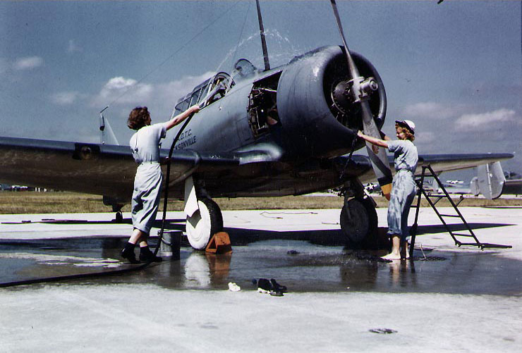 WAVES personnel washing a SNJ training aircraft, Naval Air Station, Jacksonville, Florida, United States, circa 1943-1945; note SNB aircraft in background