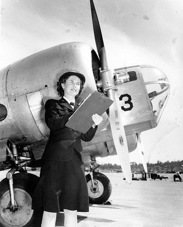 WAVES personnel Bernice Garrott marking off an aircraft check-off list, Naval Air Station, Seattle, Washington, United States, 7 Jul 1943; note SNB-1 training aircraft