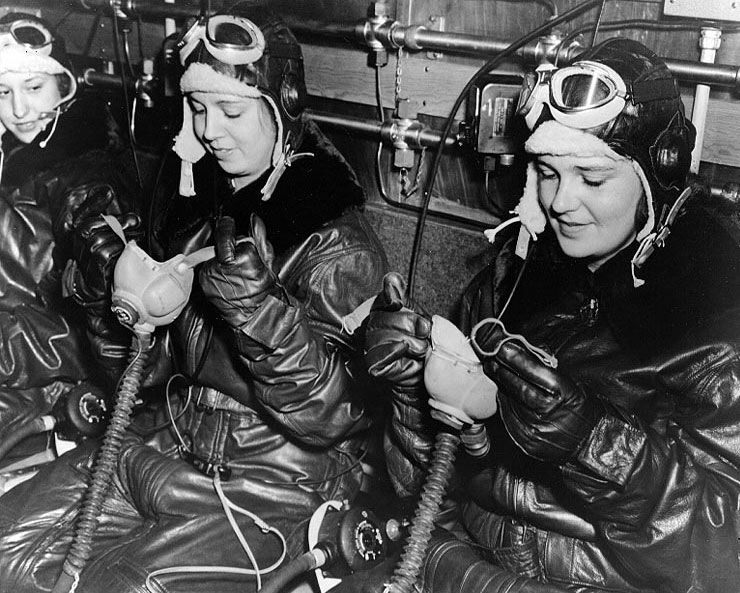 WAVES personnel putting on oxygen masks in preparation of flight simulation in chill chamber,  Naval Air Station, Jacksonville, Florida, United States, 15 Oct 1943