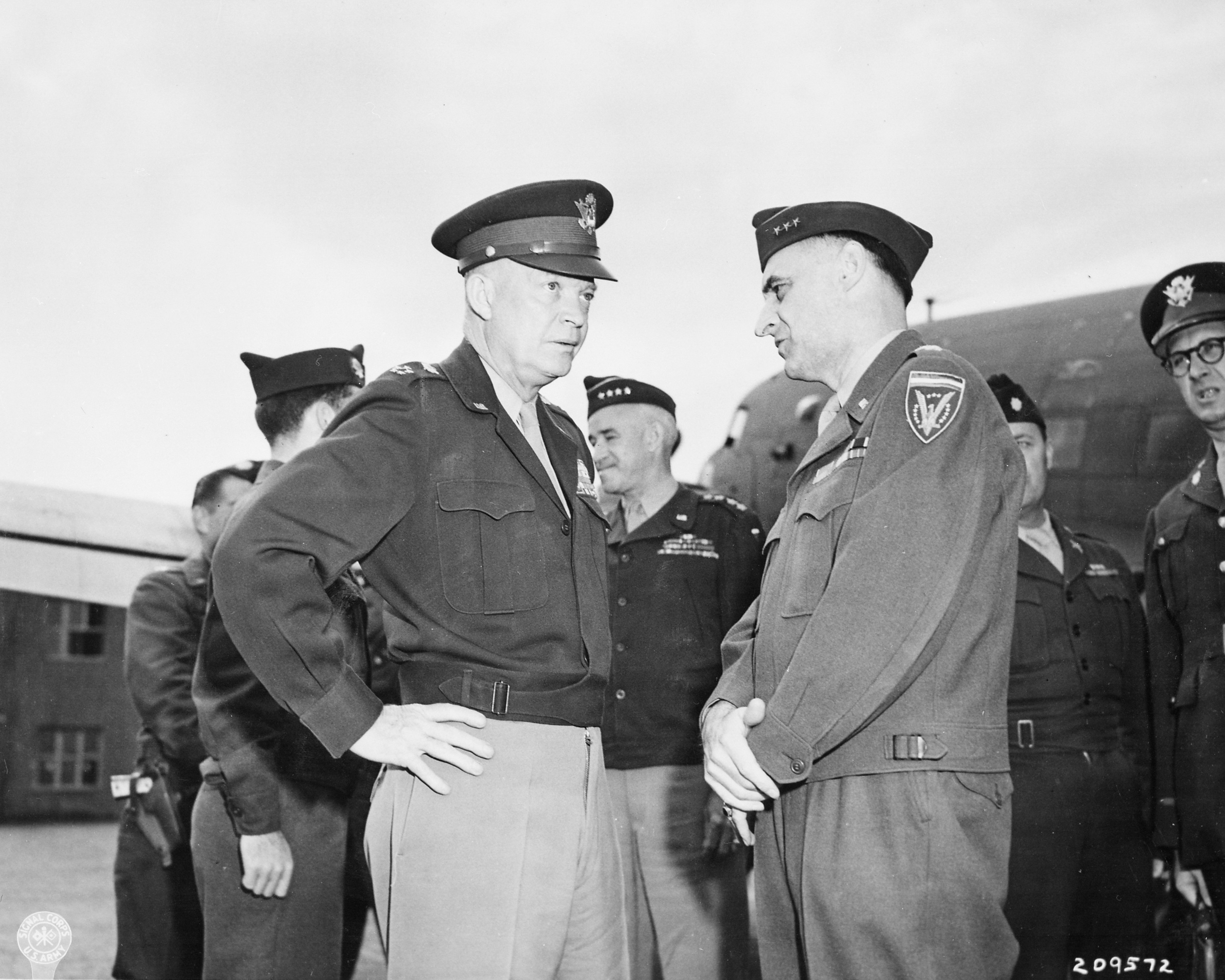 Dwight Eisenhower and Lucius Clay at the airfield in Gatow, Berlin, Germany, 20 Jul 1945; note Omar Bradley in background