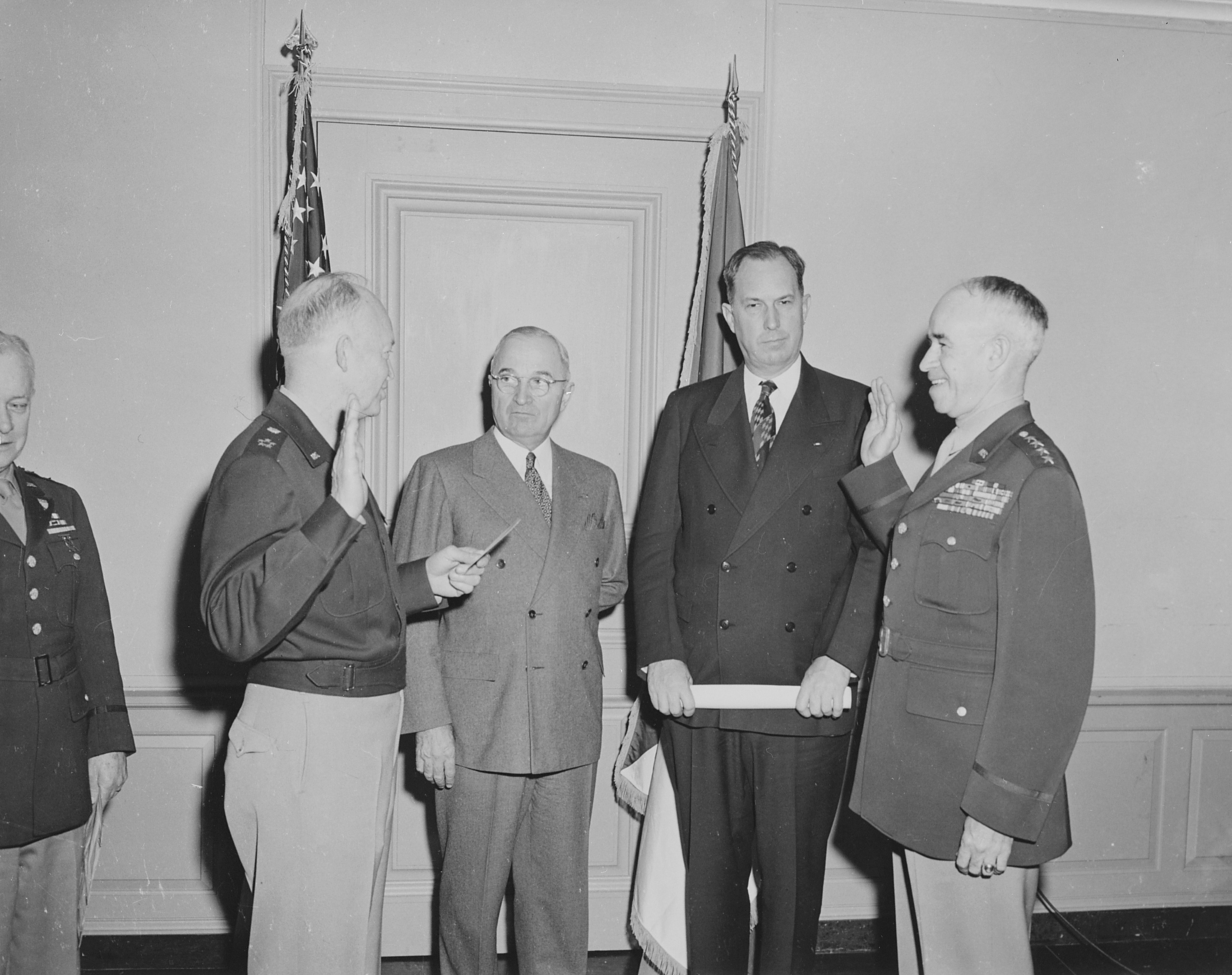 General Dwight Eisenhower swearing General Omar Bradley into office as Chief of Staff of the US Army, Pentagon, Arlington, Virginia, United States, 7 Feb 1948, photo 3 of 3; note US President Harry Truman and Secretary of Army Kenneth Royall in background