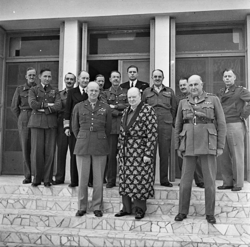 Dwight Eisenhower and Winston Churchill in Tunisia, 25 Dec 1943, photo 1 of 2; Churchill was in a robe in this photo because he was recovering from pneumonia