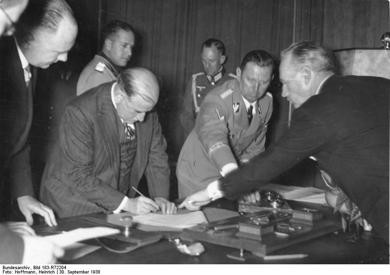 French Prime Minister Daladier signing the Munich Agreement, 30 Sep 1938; note Galeazzo Ciano in background and Joachim von RIbbentrop pointing