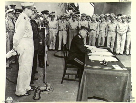 General Kuzma Nikolaivich Derevyenko signing the surrender instrument on behalf of the Soviet Union aboard USS Missouri, Tokyo Bay, Japan, 2 Sep 1945, photo 1 of 2