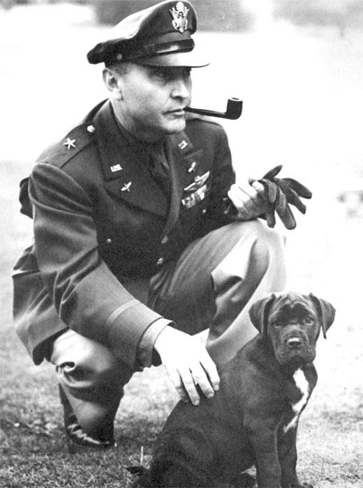 Brigadier General Ira Eaker in Britain, playing with a dog, 1942-1944
