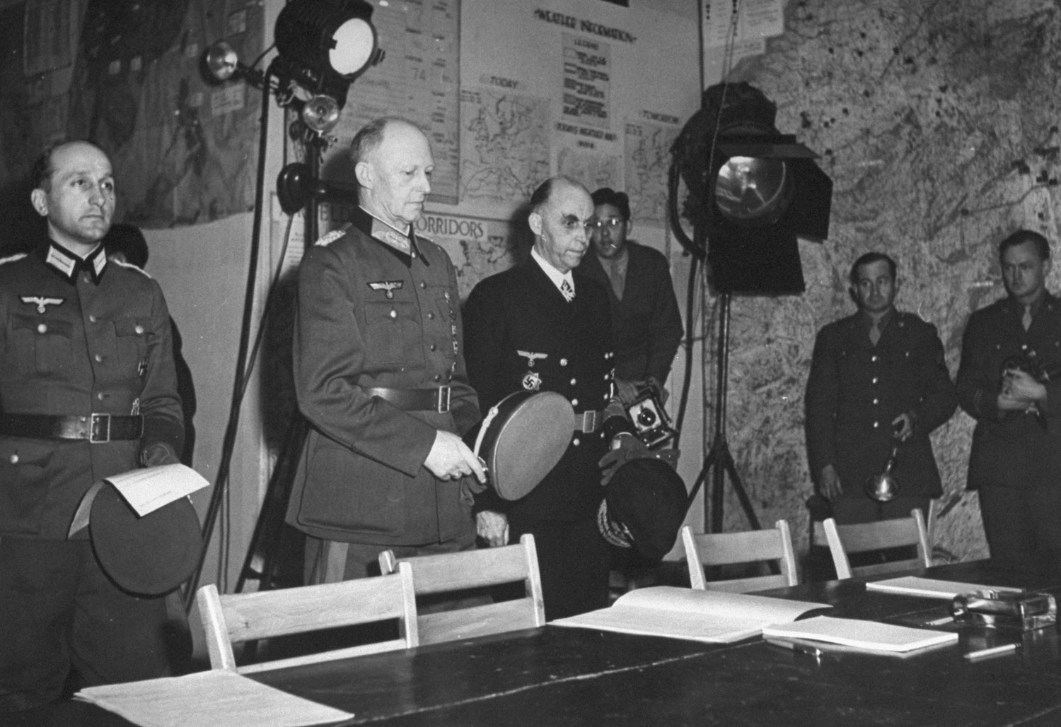 ColGen Alfred Jodl approaching the table with the documents of surrender, Reims, France, 7 May 1945. His aide, Maj Wilhelm Oxenius, is on the left and Kriegsmarine Admiral Hans-Georg Von Friedeburg is on the right