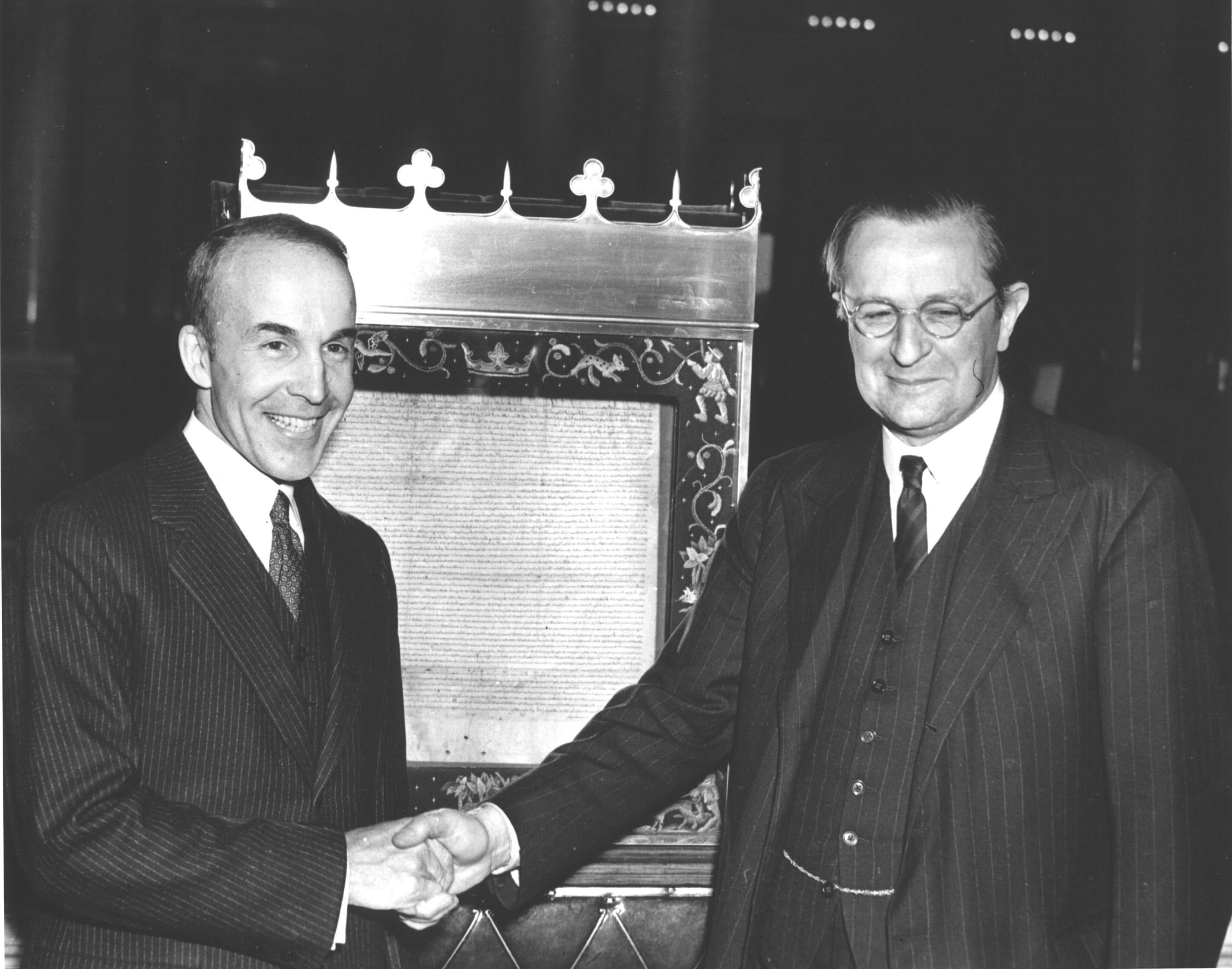 Head of the United States Library of Congress Archibald MacLeish and British Ambassador Lord Lothian posing in front of the Magna Carta, Washington, DC, United States, 28 Nov 1939