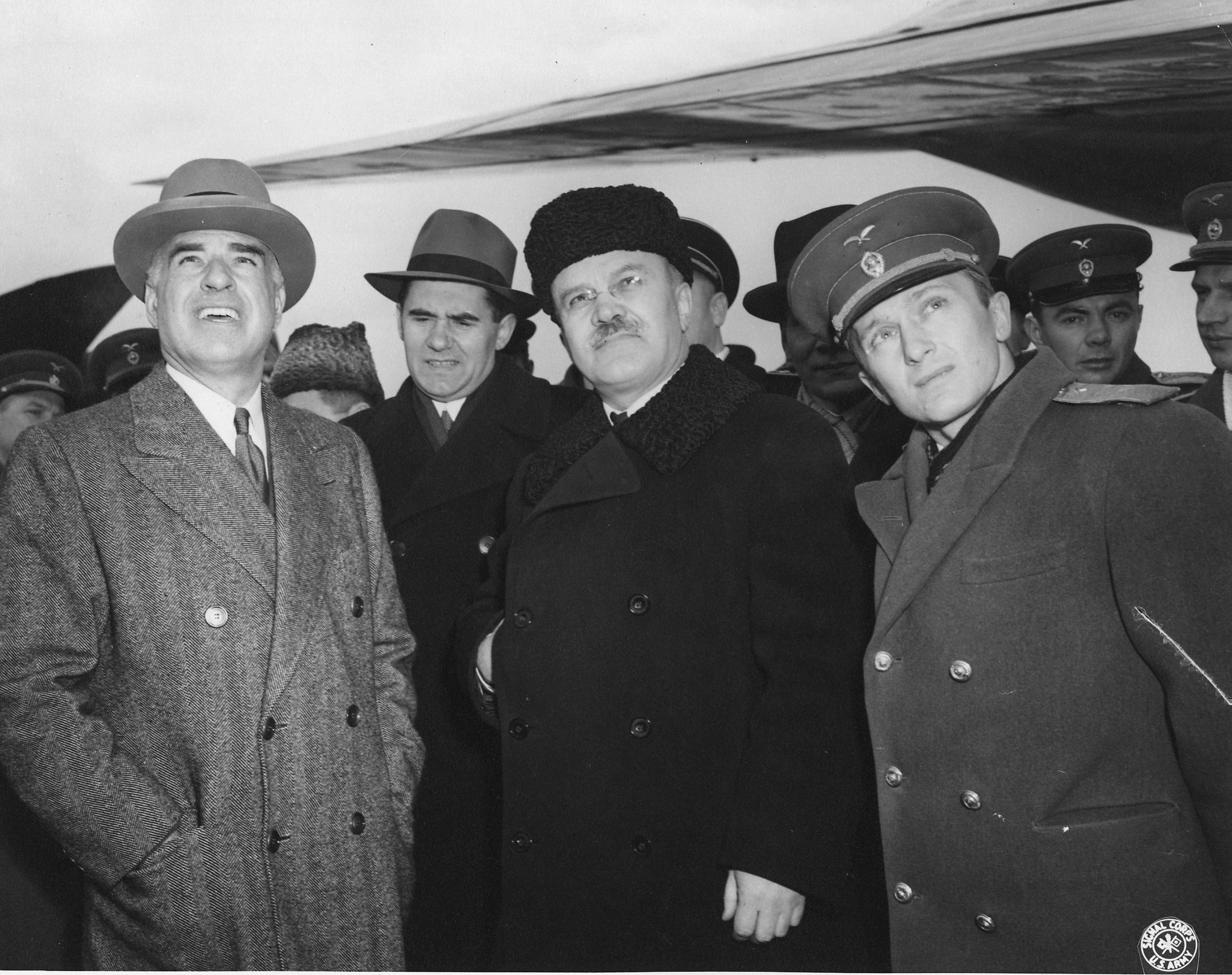 US Secretary of State Edward Stettinius, Jr., Soviet diplomat Andrei Gromyko, and Soviet Foreign Minister Vyacheslav Molotov scanning the sky for the arrival of US President Franklin Roosevelt's aircraft, Crimea, Russia (now Ukraine), 3 Feb 1945