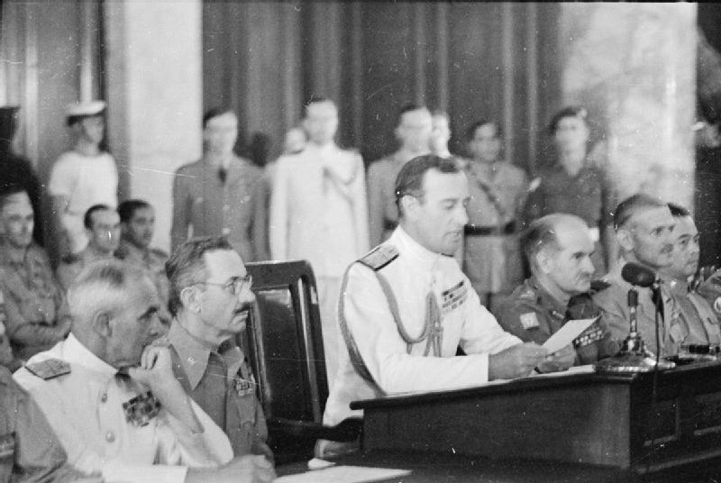 Louis Mountbatten reading surrender terms to Japanese representatives at the surrender ceremony at Municipal Building, Singapore, 12 Sep 1945