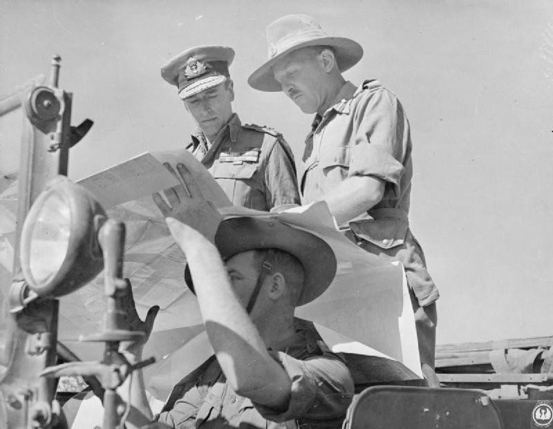 Louis Mountbatten studying a map near Mandalay, Burma aboard a WC command car, 13-18 Jan 1945