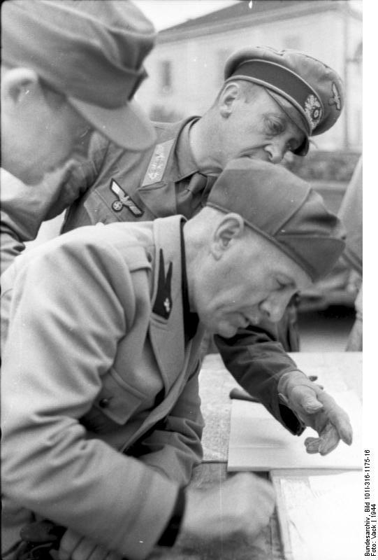 Benito Mussolini studying a map with a German general, Italy, 1944
