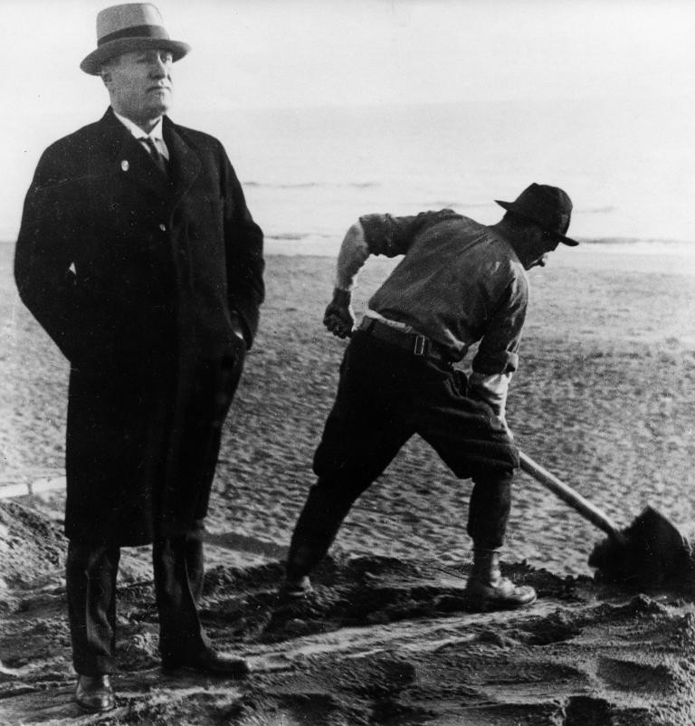 Benito Mussolini standing next to a worker, Ostia, Rome, Italy, 1931