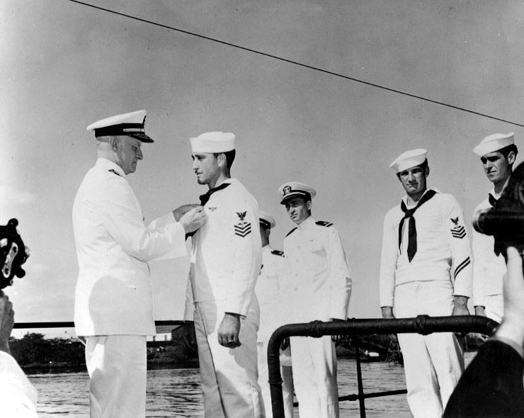 Admiral Nimitz presenting the Navy Cross award to Aviation Machinist's Mate First Class Wagoner aboard USS Grayling, Pearl Harbor, US Territory of Hawaii, 31 Dec 1941