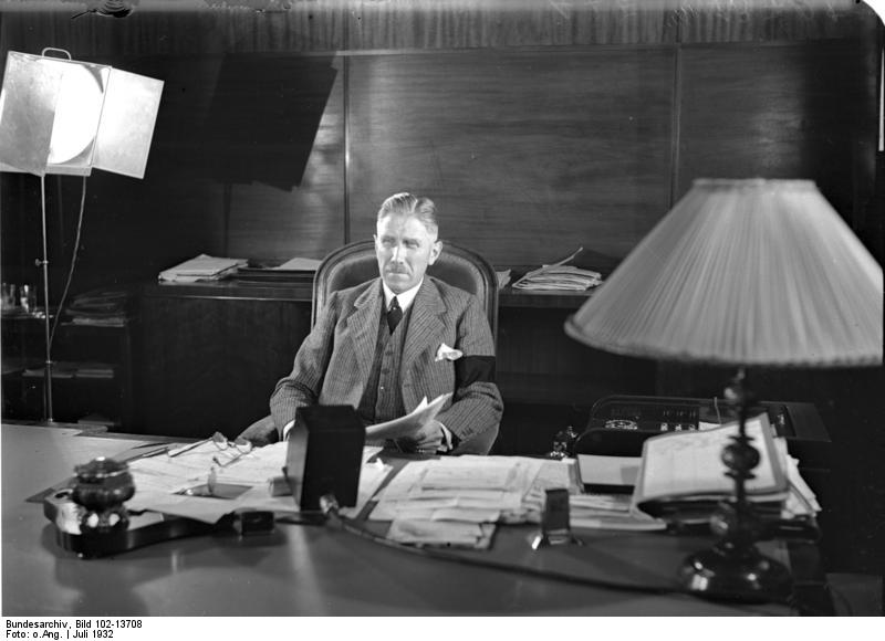 German Chancellor Papen in his office in Berlin, Germany, making a speech to an American audience over radio, Jul 1932