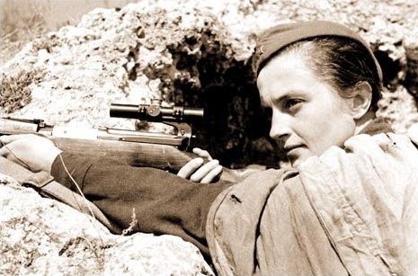 Pavlichenko posing with her Mosin-Nagant sniper rifle for a publicity photo shoot, date unknown