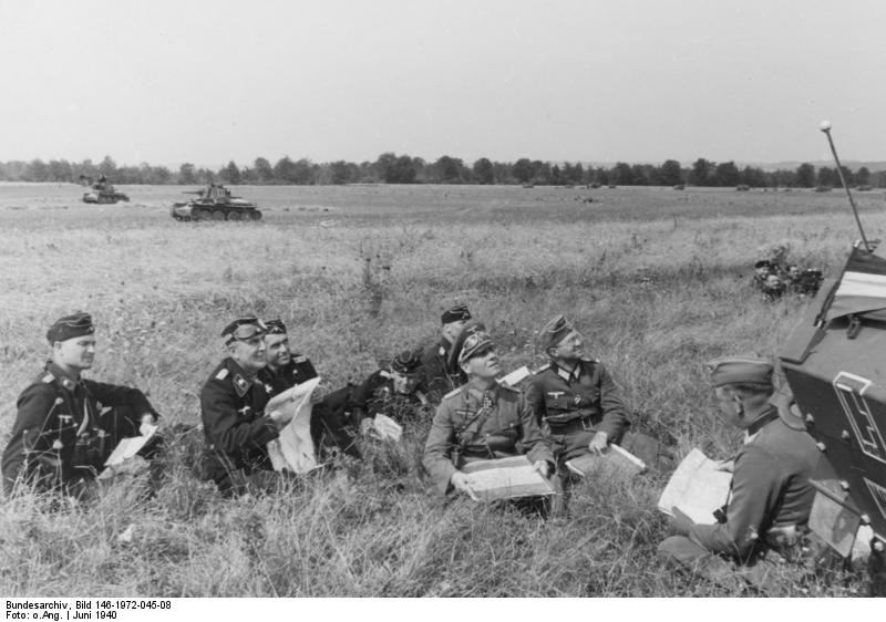 German Major General Rommel in a field in France, Jun 1940; note Panzer 38(t) tanks in the background