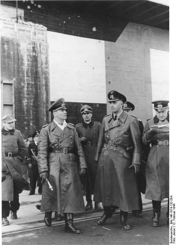Field Marshal Erwin Rommel and Vice Admiral Friedrich Oskar Ruge touring a submarine pen on the Atlantic coast, France, 12 Feb 1944