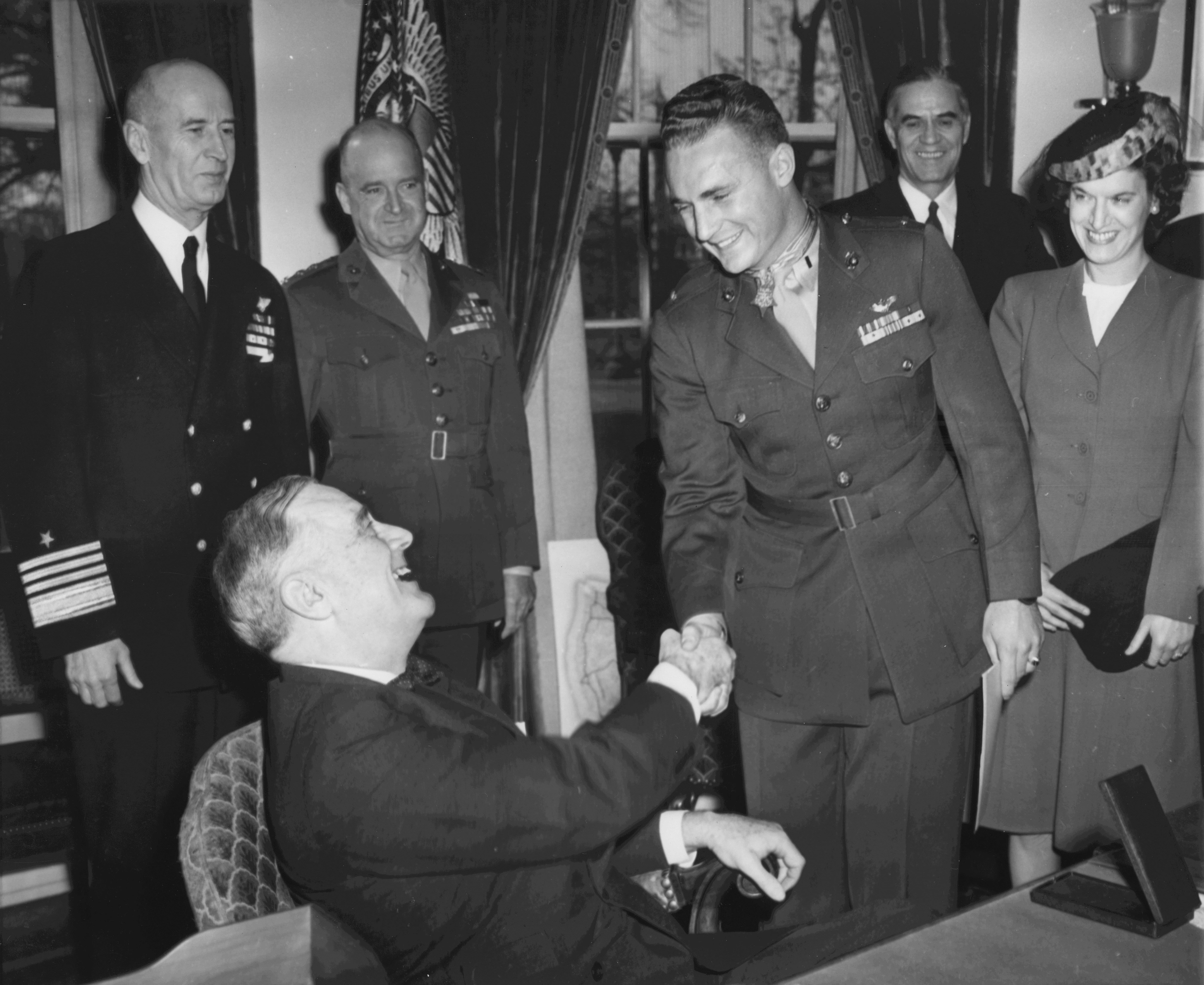 Franklin Roosevelt with USMC pilot Kenneth Walsh at the White House, Washington DC, United States, 8 Feb 1944; note Adm Ernest King, LtGen Alexander Vandegrift, Asst Secretary of Navy Ralph Bard, and Mrs Walsh