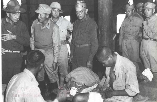 US General Daniel Sultan, Chinese General Sun Li-jen, and medical doctor Gordon Seagrave visiting wounded Chinese troops in a field hospital, Burma, 1940s