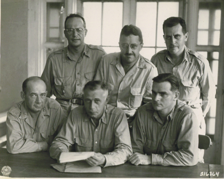 Yamashita's defense counsels, Oct 1945.  Seated: Lt. Col. Gordon Feldhaus, Col. Harry E. Clarke, Sr., Lt. Col. Walter Hendricks.  Standing: Capt. Frank Reel, Maj. George Guy, Capt. Milton Sandberg