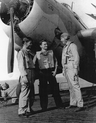 Aviation Radioman 1st Class E. L. Feehan, Aviation Ordnanceman 2nd Class S. J. Pocotny, and Lieutenant Commander J. J. Lynch aboard USS Coral Sea, 30 Oct 1943