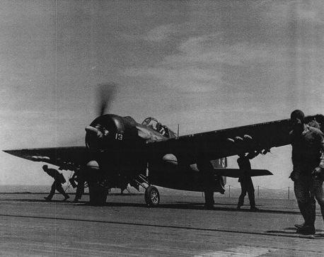 Armorers equipping a F4F Wildcat fighter with HVAR rockets aboard USS Anzio, 20 Apr 1945 off Okinawa.