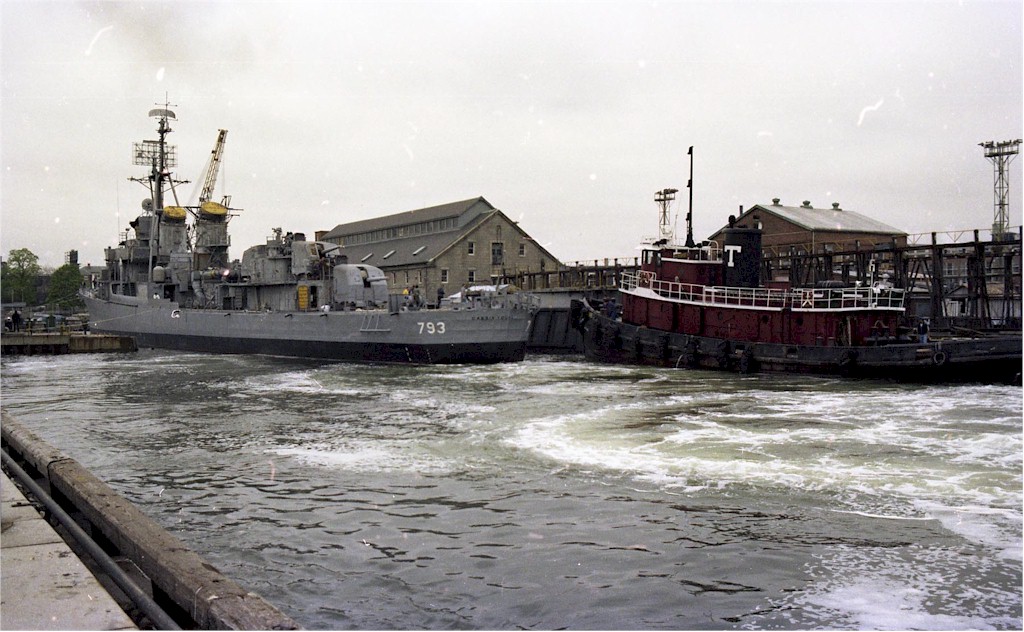 Boston Towing tugboat Mars towing USS Cassin Young from Dry Dock 1 of Charlestown Navy Yard, Massachusetts, United States, May 1981