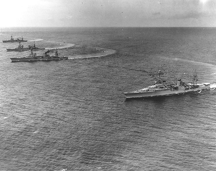 Louisville, Salt Lake City, Northampton, and Chicago turning in formation with three other Scouting Force heavy cruisers to create a slick for landing seaplanes, off Pearl Harbor, Hawaii, 31 Jan 1933