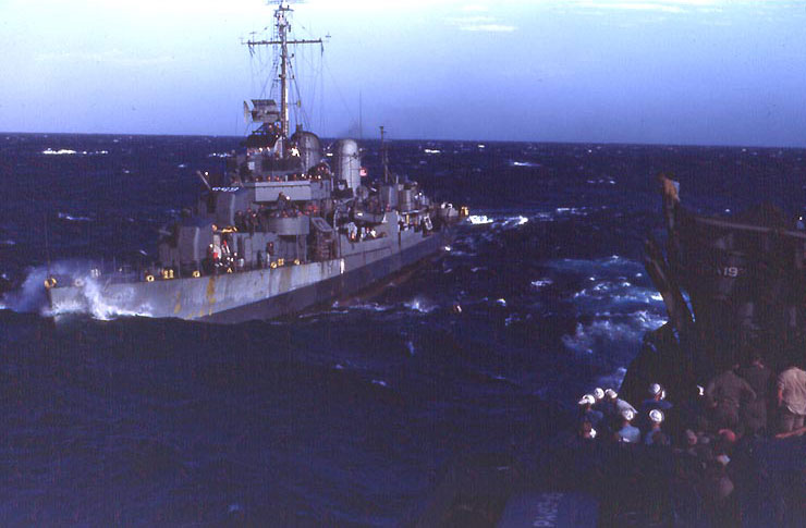 Destroyer Cotten steaming at sea, circa 1945, photo 7 of 7; men of APA Sanborn in foreground
