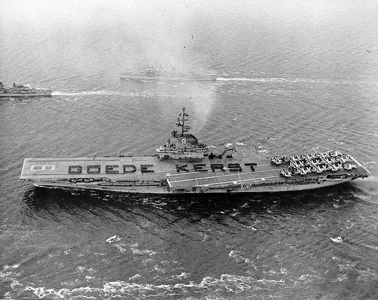 Men of USS Essex spelling out 'Goede Kerst' (Merry Christmas) on the flight deck, off Rotterdam, the Netherlands, 29 Dec 1961