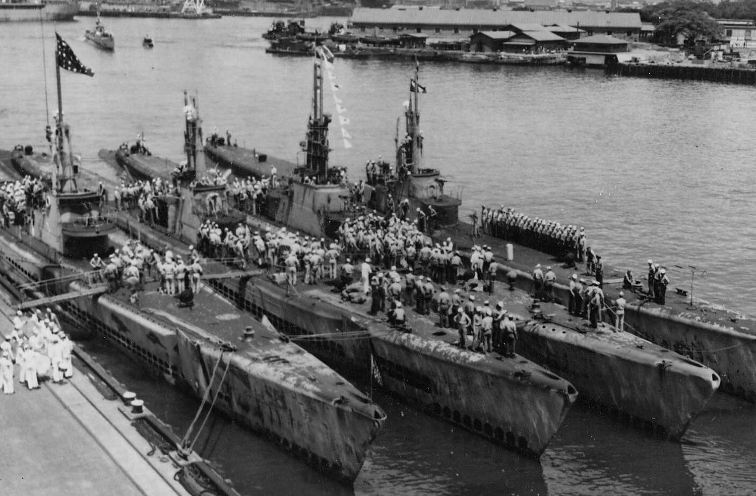 Five of Hydeman's Hellcats upon their return from Operation Barney: USS Flying Fish, USS Spadefish, USS Tinosa, and USS Bowfin in port with USS Skate approaching, Pearl Harbor, US Territory of Hawaii, 4 Jul 1945